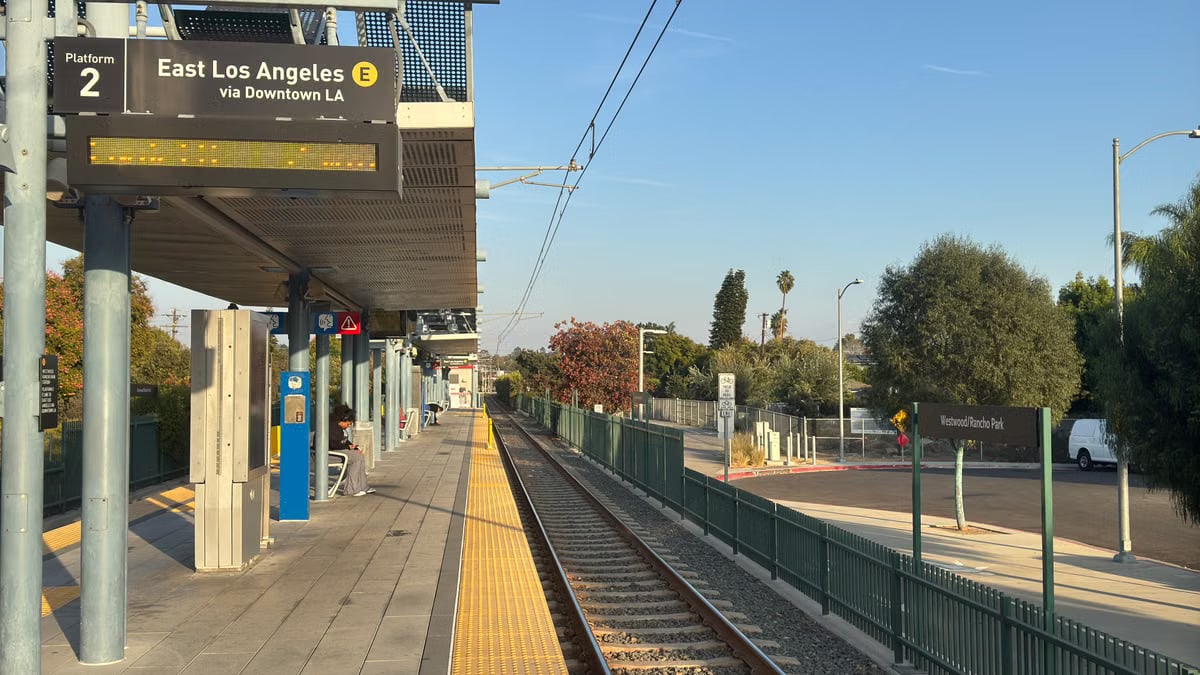 East Los Angeles train station platform with empty tracks during sunset.